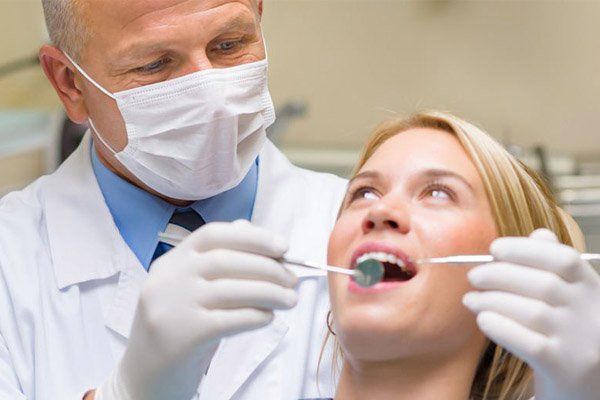 dentist working on teeth on patient