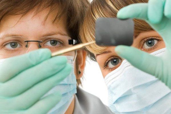 dentists looking at tooth xray