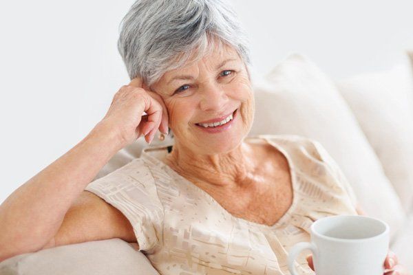mature woman smiling with cup of coffee