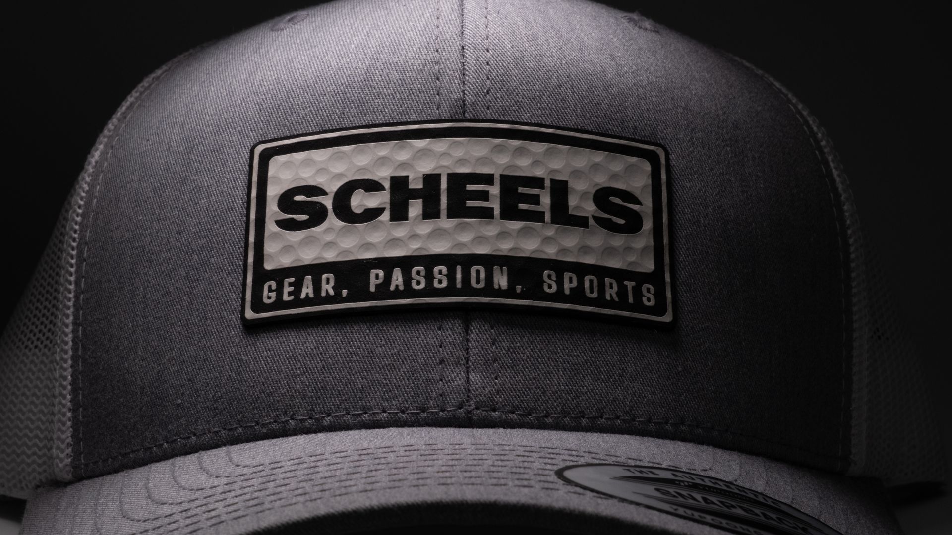 A dark gray cap featuring a rectangular patch with 