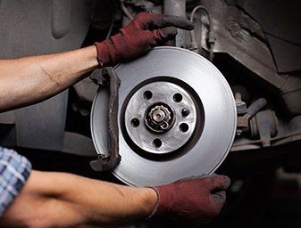 Car Mechanic Repairing Brakes — Brakes Service & Repair in Syracuse, NY