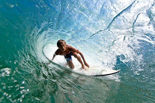 A surfer in the barrel of a wave.