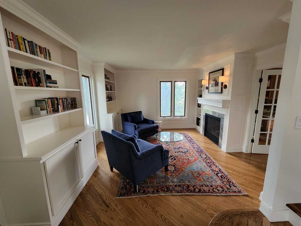A living room with a fireplace and a flat screen tv
