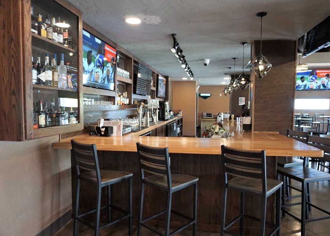 A restaurant with tables and chairs and a fire extinguisher on the wall.