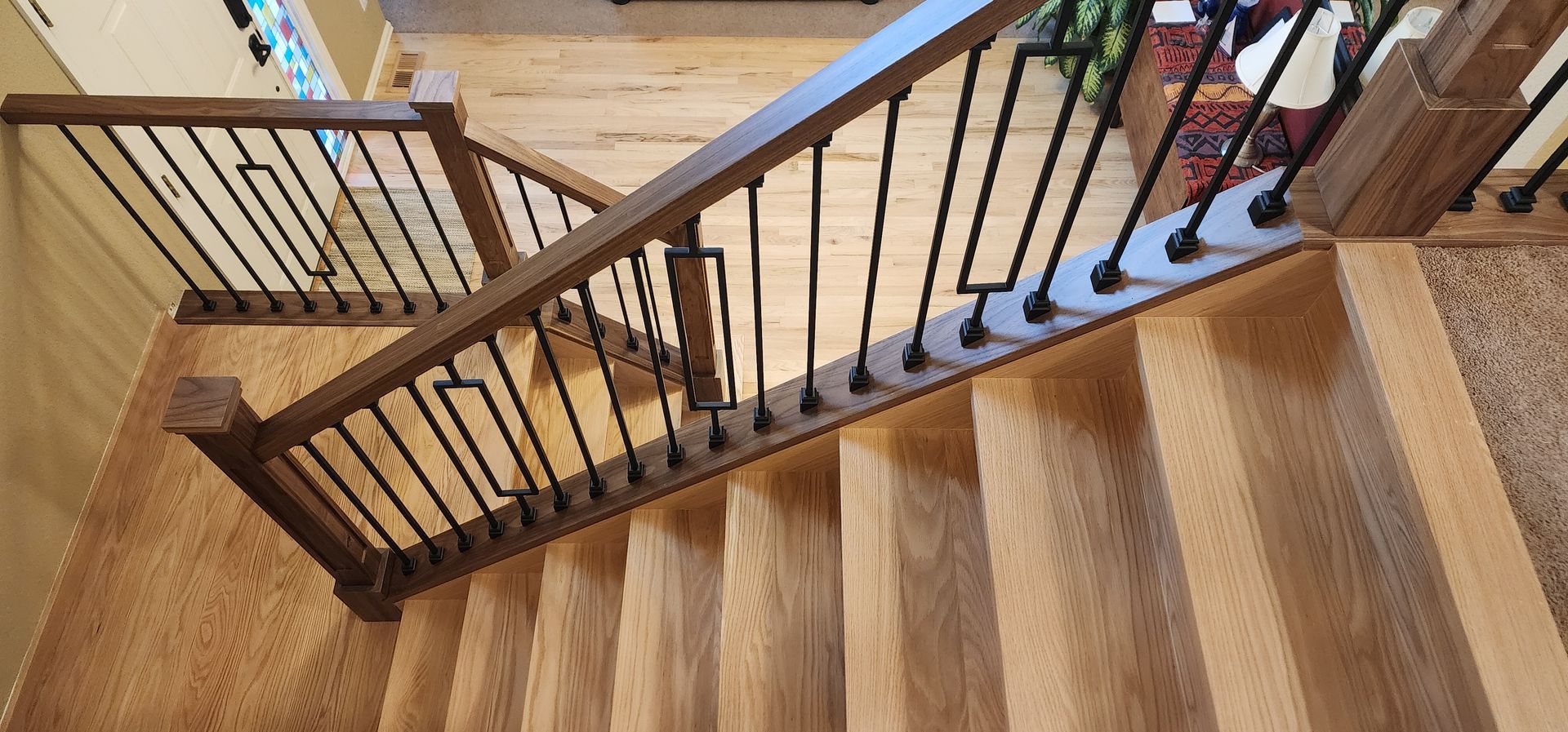 Interior of a bar with tables, chairs, and a long bar with stools. Multiple TVs are mounted on the wall.