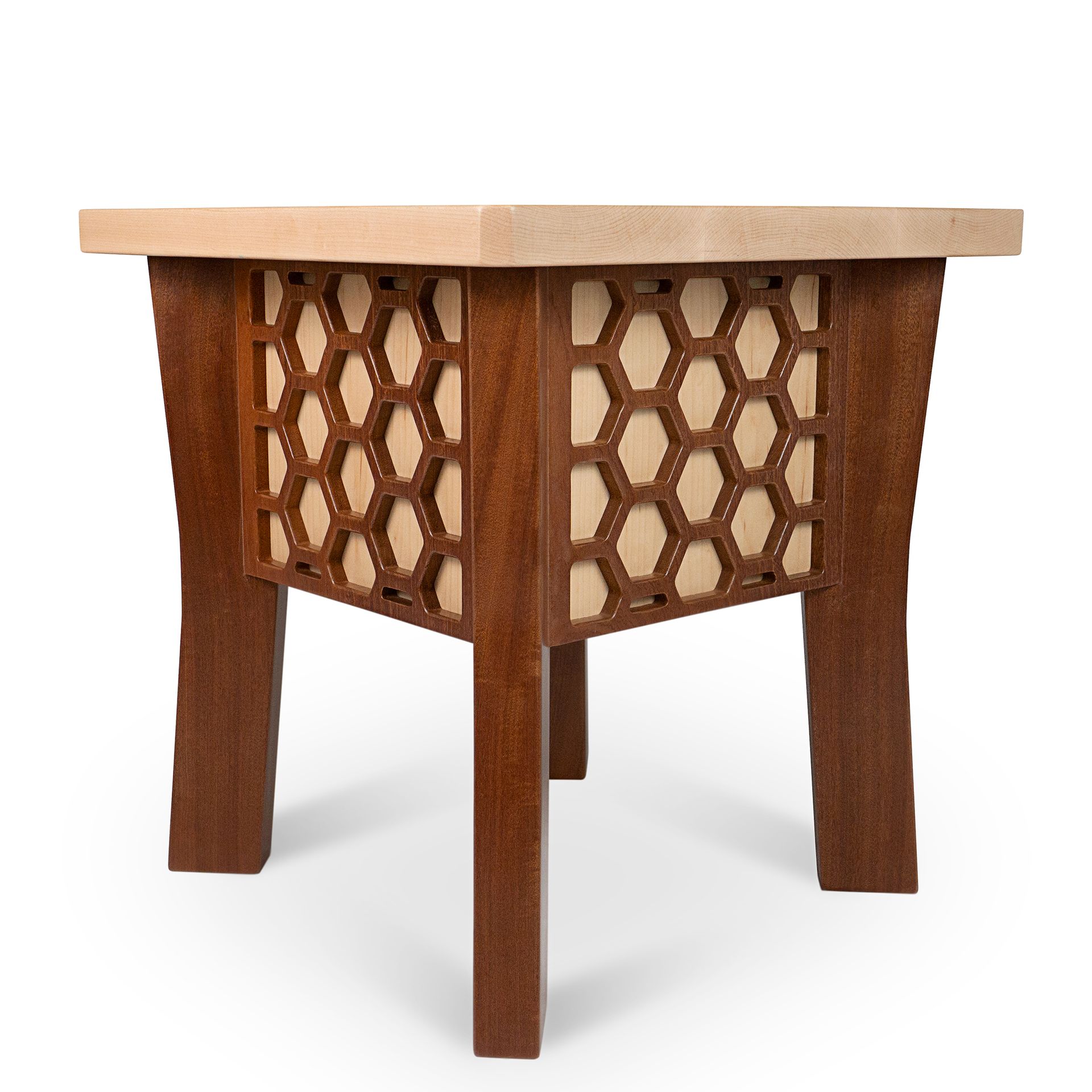 Wooden side table with honeycomb-patterned sides and light-colored top. Brown legs taper outwards.