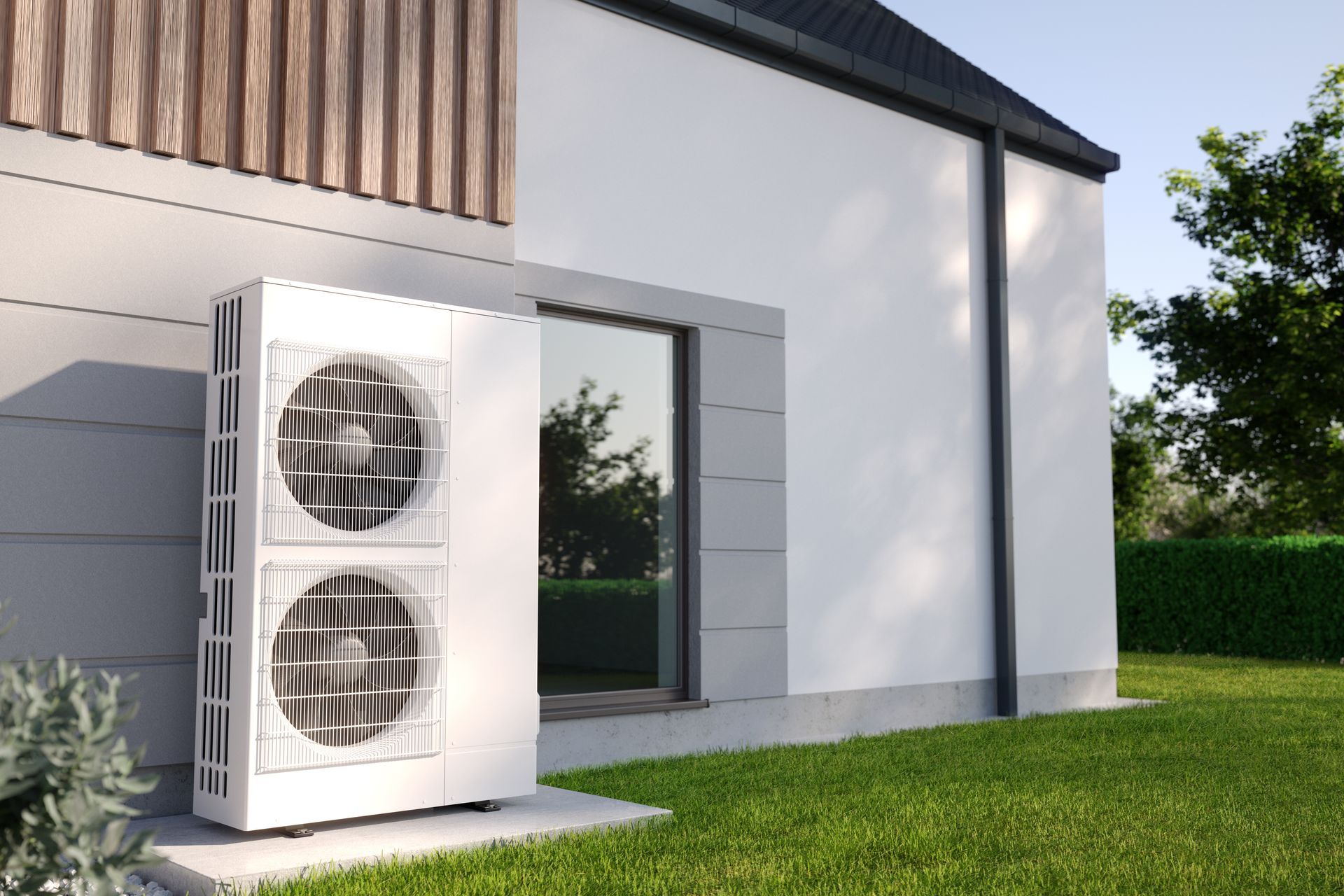 A white air conditioner is sitting on the side of a house.