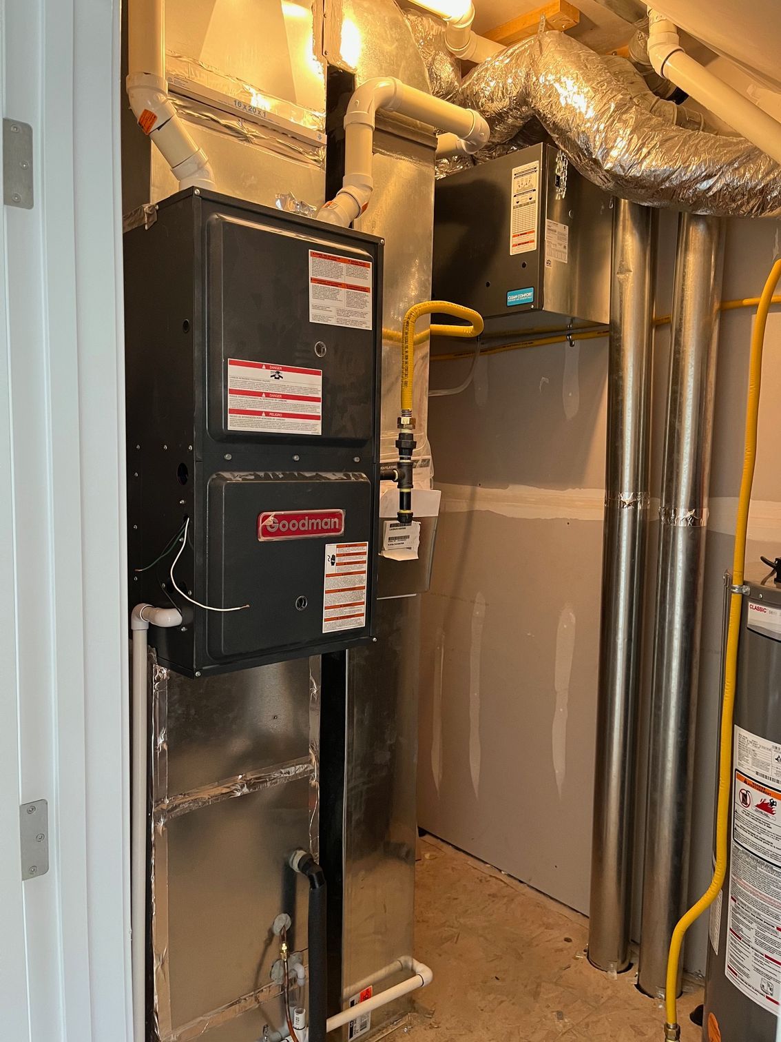 A room with a heater and a furnace in it.