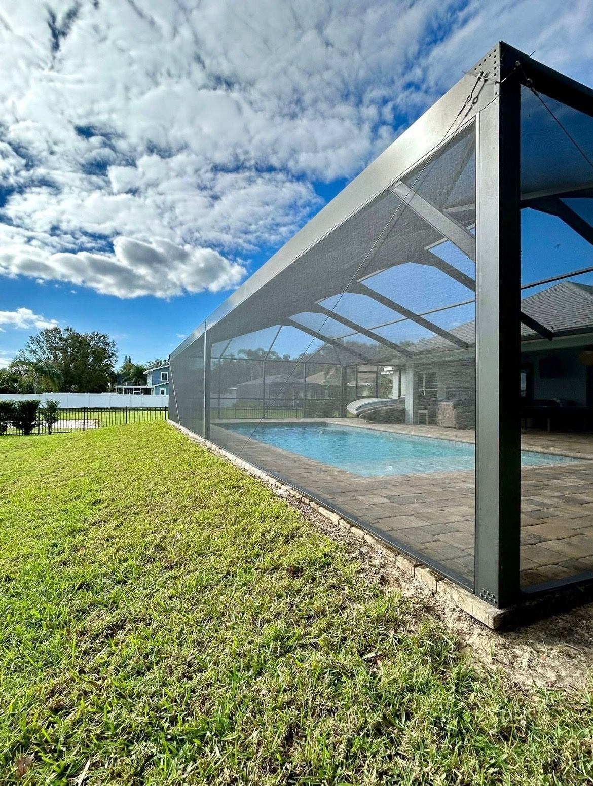 Modern apartment interior with white walls, large windows, and a sofa.