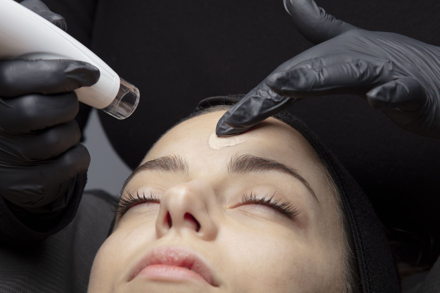 A woman is getting a facial treatment at a beauty salon.
