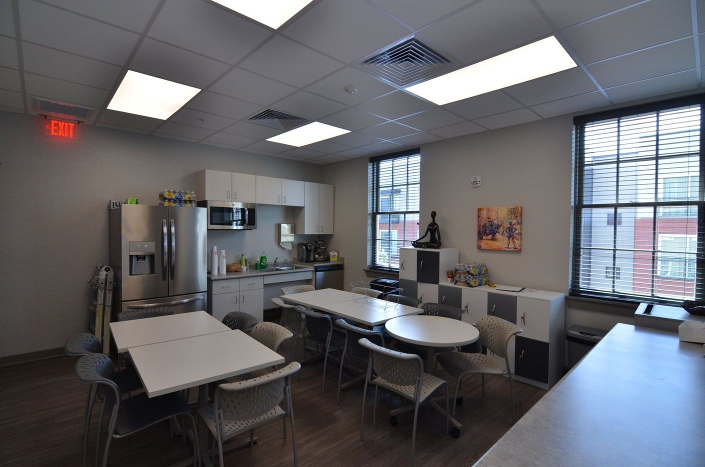 A kitchen with a red exit sign on the ceiling