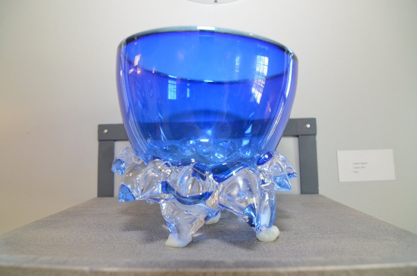 A blue glass bowl is sitting on a table