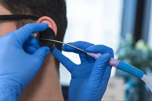 Happy Ears Ear Wax Removal specialist using microsuction to remove ear wax from a client