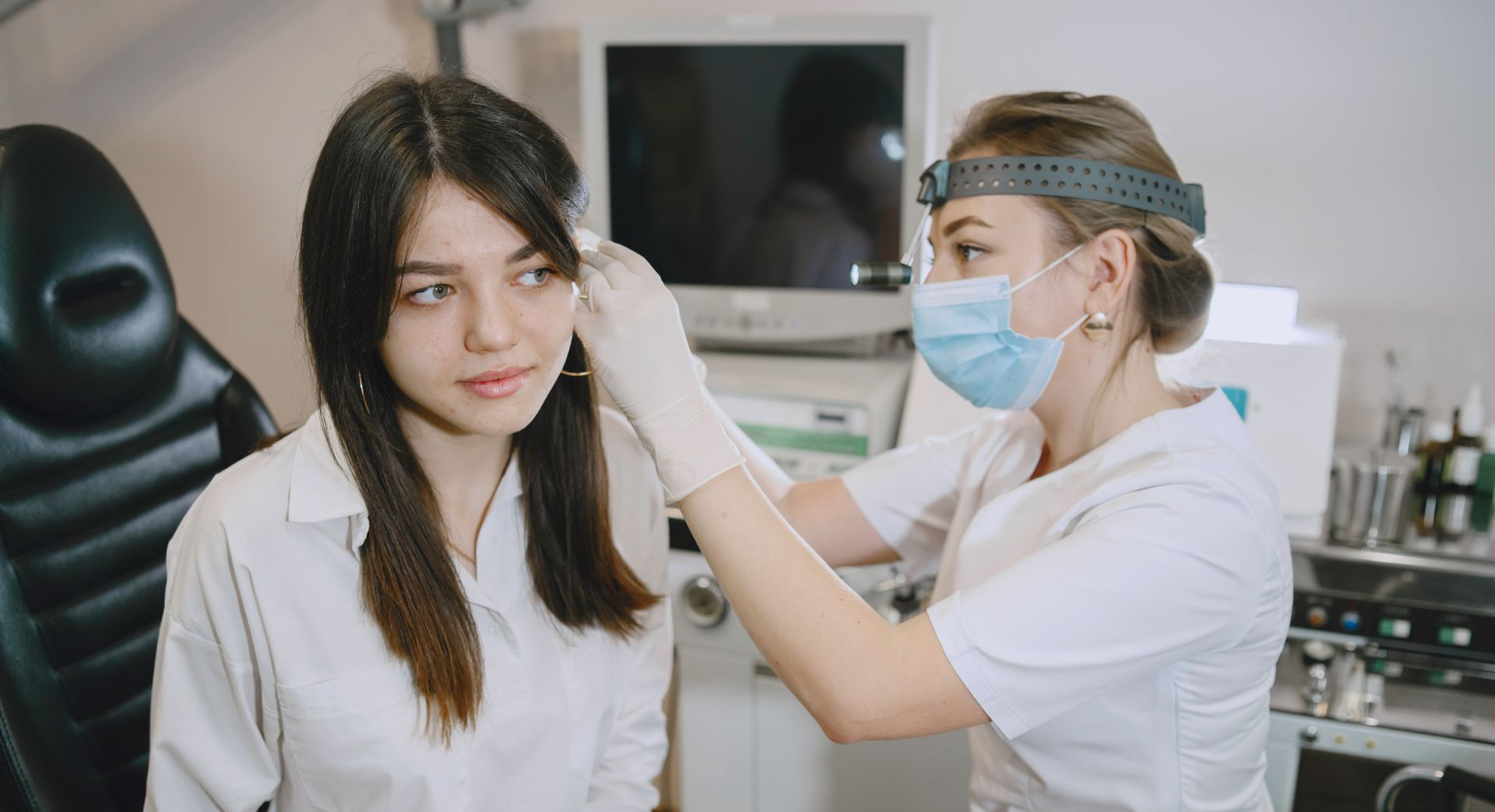 Happy Ears Ear Wax removal specialist examining ears for ear wax
