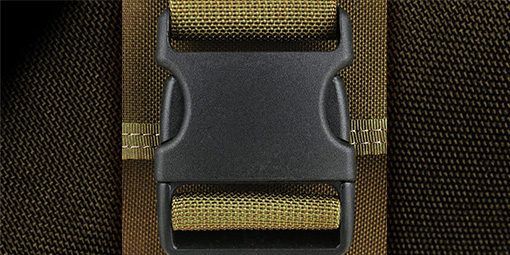 A close up of a black plastic buckle on a brown strap.