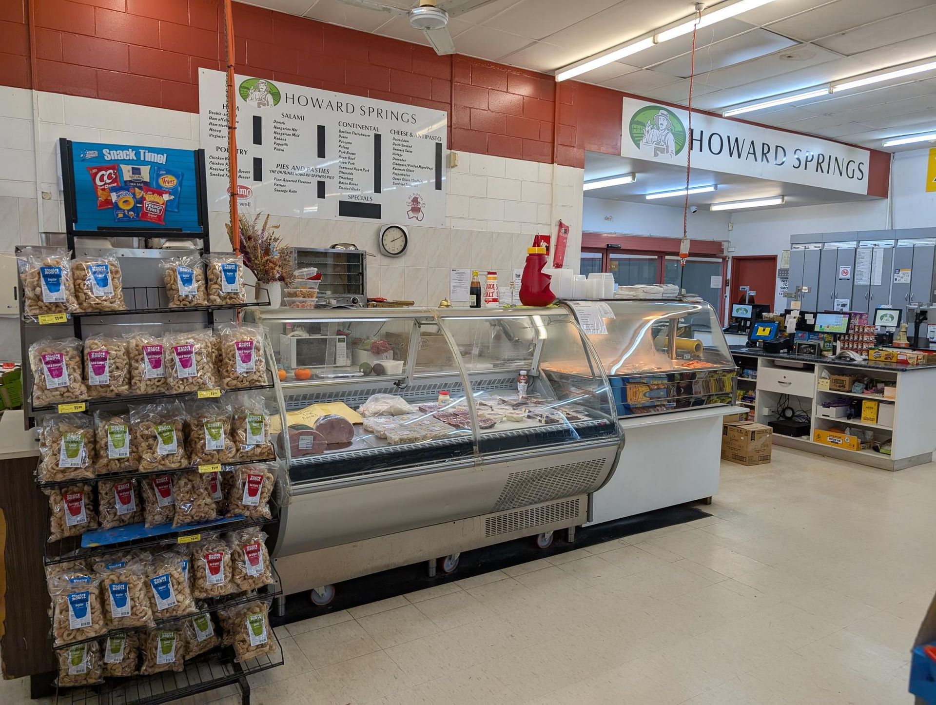 A Plate of Meat and Tomatoes on a Cutting Board — Howard Springs Supermarket In Howard Springs, NT