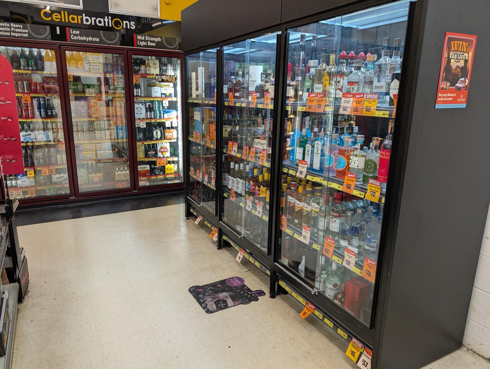 Bottles of Wine and a Glass of Wine on a Wooden Table — Howard Springs Supermarket In Howard Springs, NT