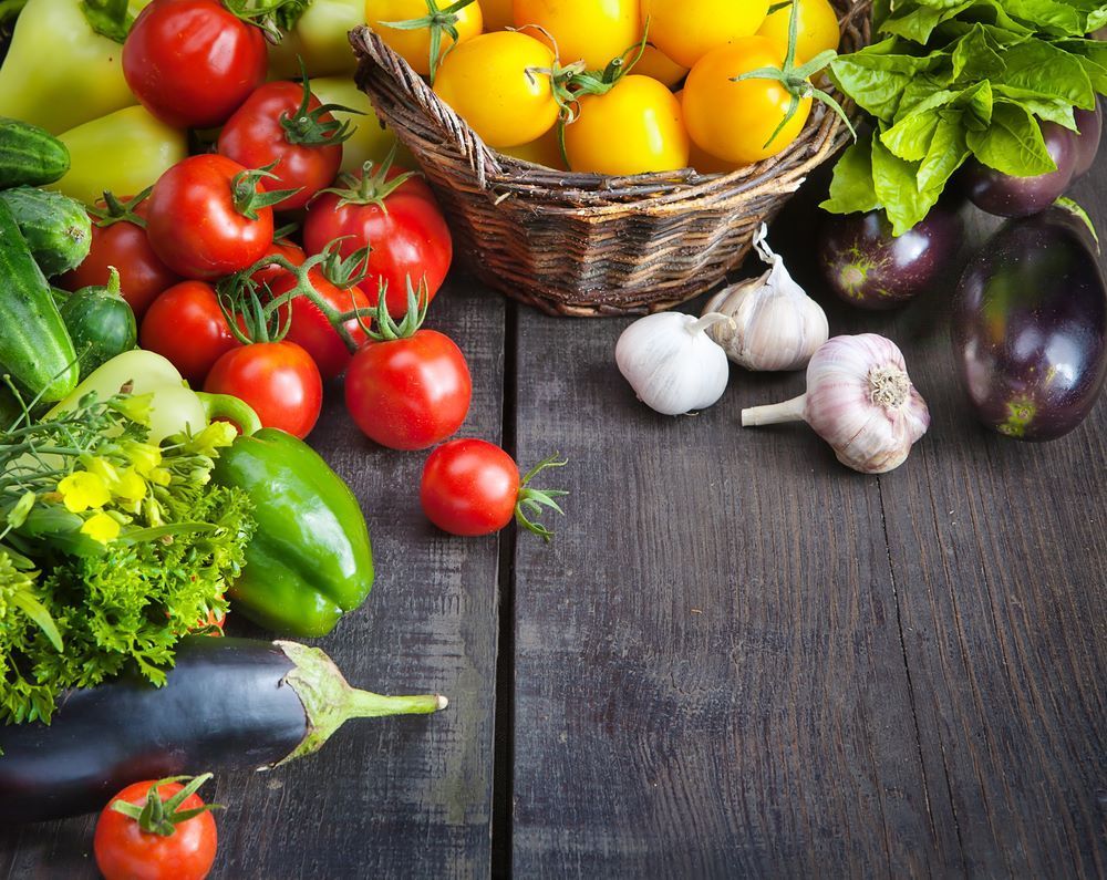 A Variety of Vegetables Are on a Wooden Table — Howard Springs Supermarket In Howard Springs, NT