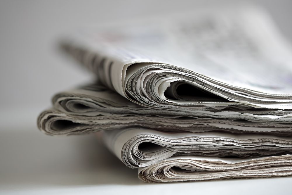 Three Newspapers Are Stacked on Top of Each Other on a Table — Howard Springs Supermarket In Howard Springs, NT