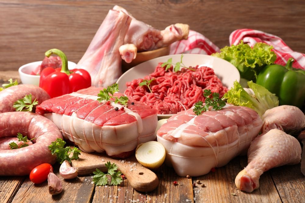 A Variety of Raw Meats and Vegetables on a Wooden Table — Howard Springs Supermarket In Howard Springs, NT