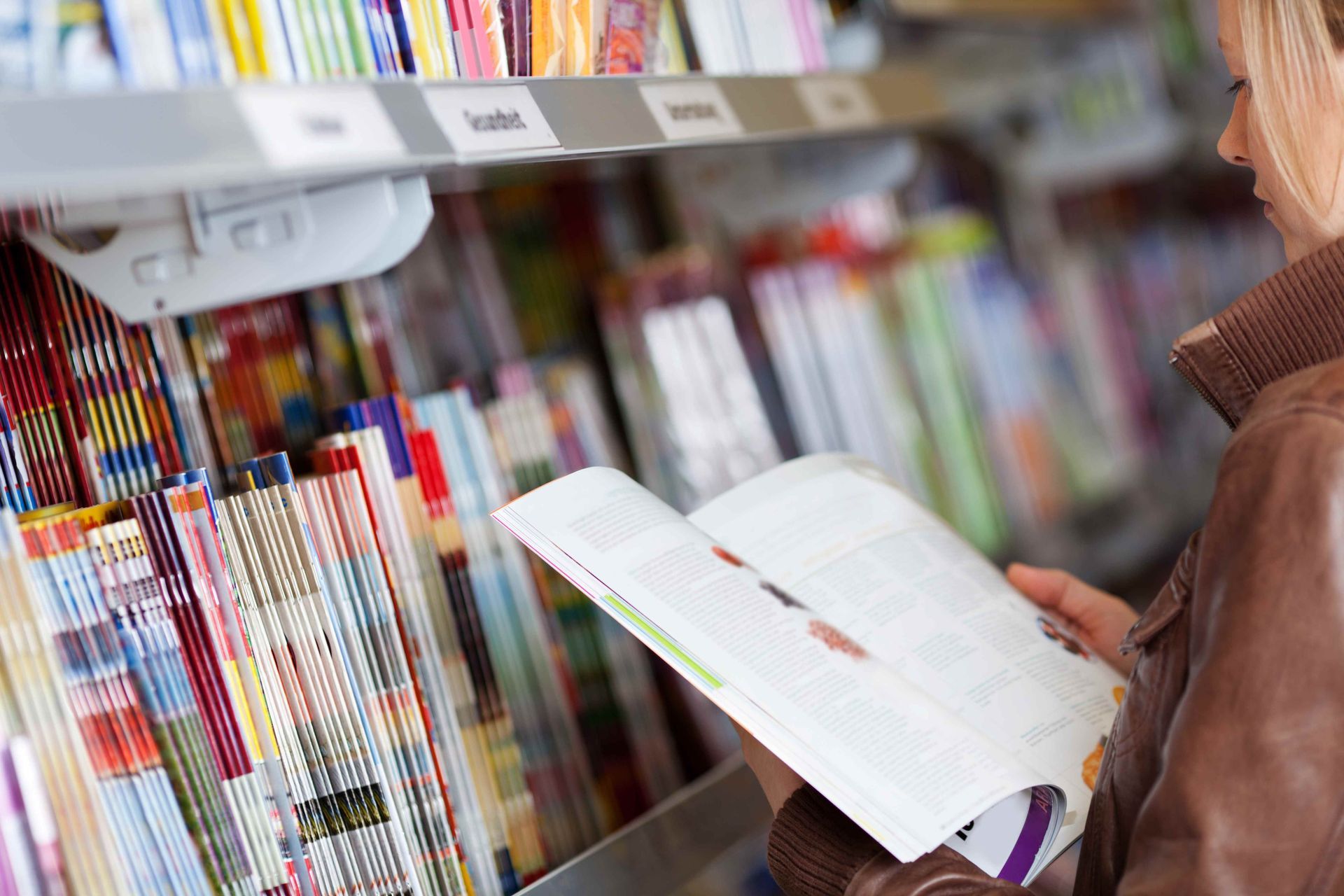 A Woman is Reading a Magazine in a Bookstore — Howard Springs Supermarket In Howard Springs, NT