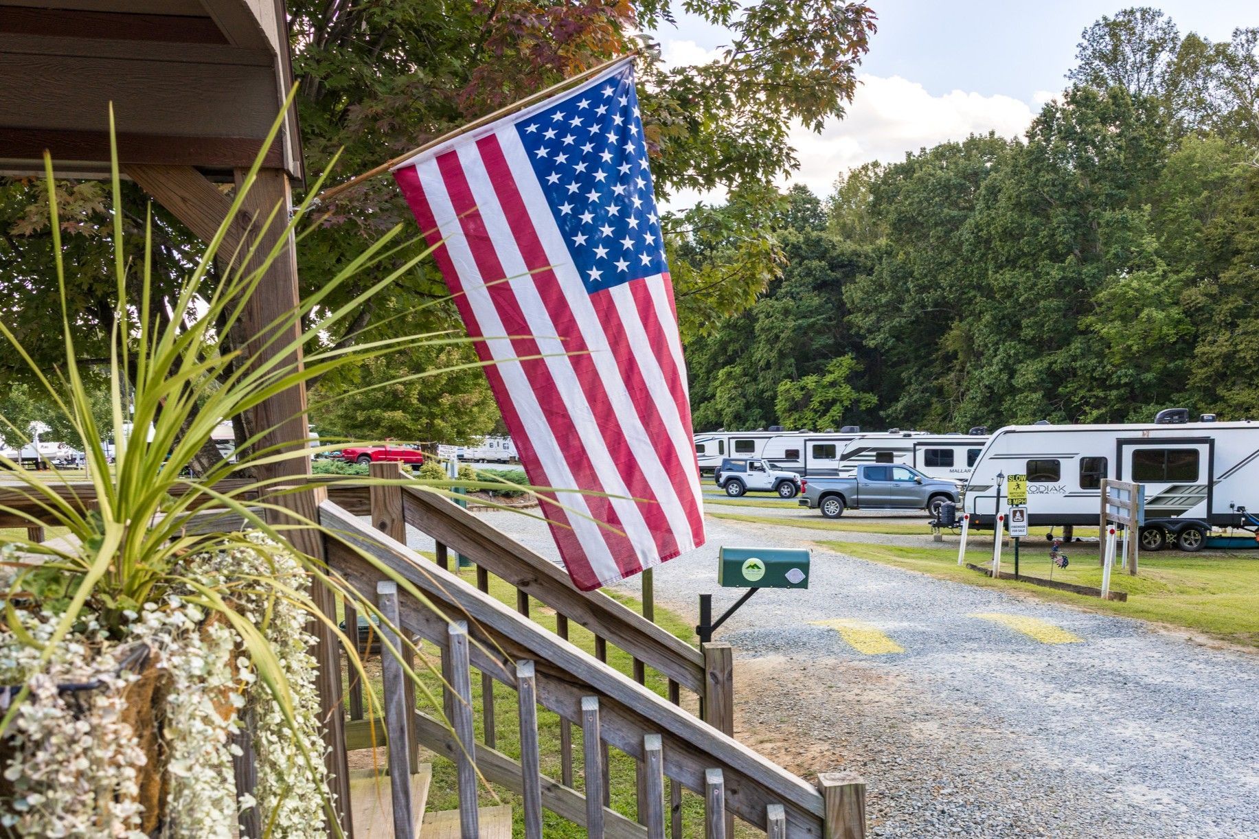 American flag outside a campground with RVs.