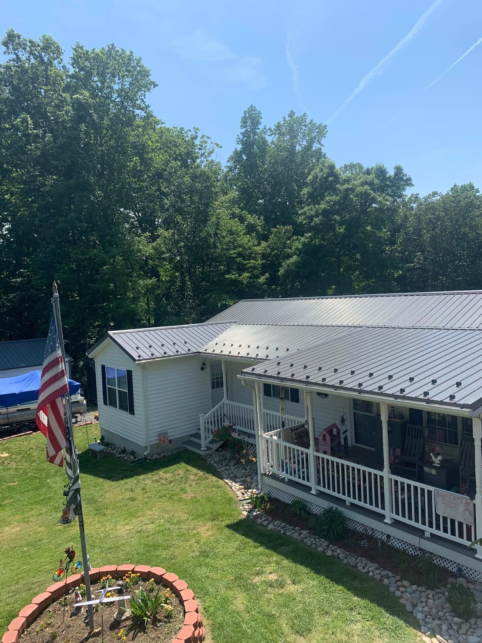 A mobile home with a porch showcasing a metal roof, Southern MD
