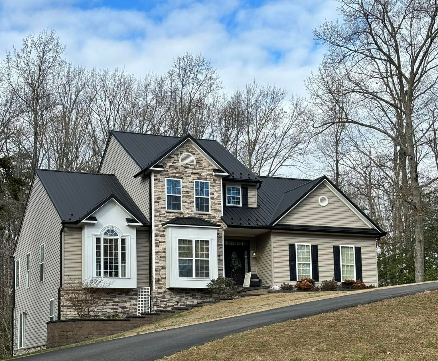 A large house with a black metal roof in Southern Maryland.