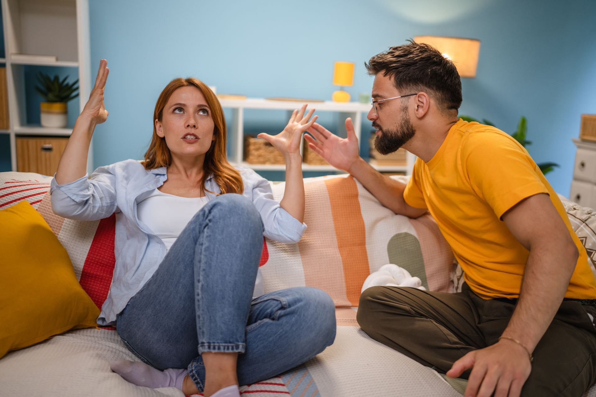 Hands of two people holding a wedding ring, a ceremony setting.