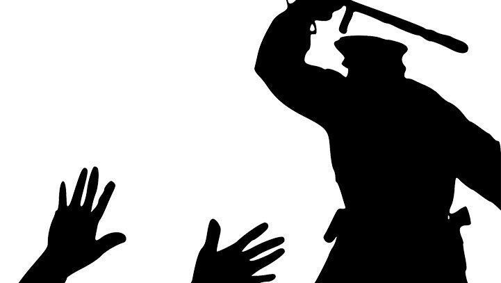 Silhouette of a person with a baton raised, and two hands raised in front.