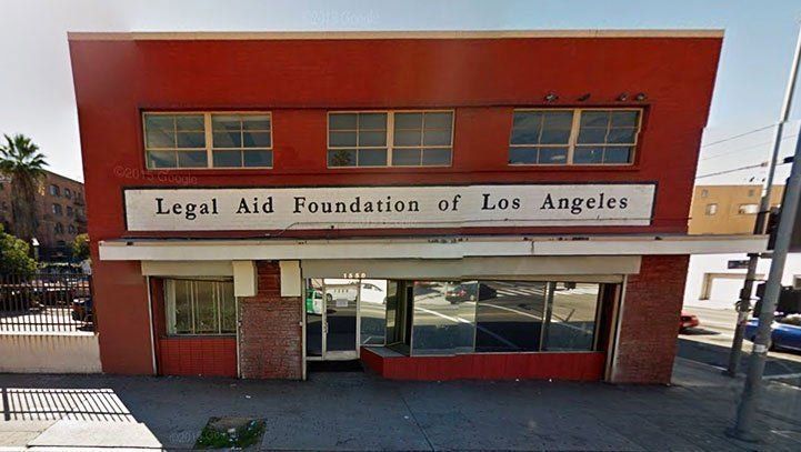 Exterior of the Legal Aid Foundation of Los Angeles building; red facade with windows and sign.