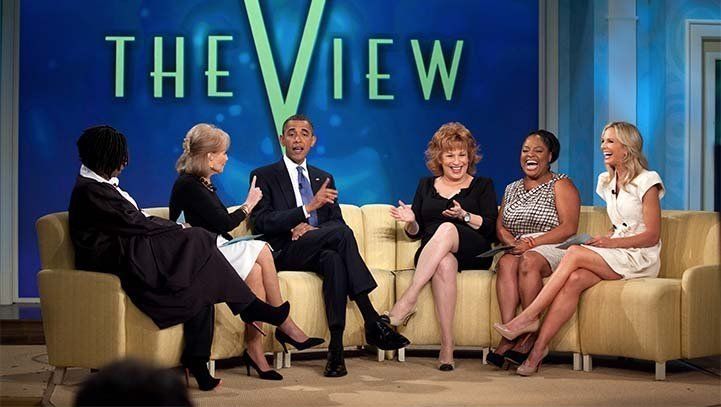 President Obama on The View, seated with hosts, smiling, in front of the show's logo.