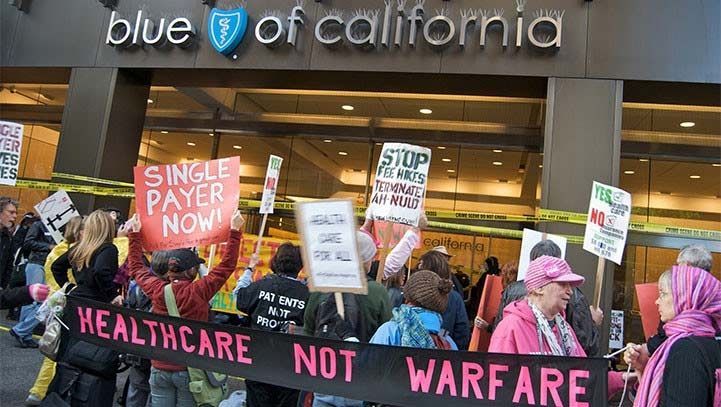 Protesters with signs, including
