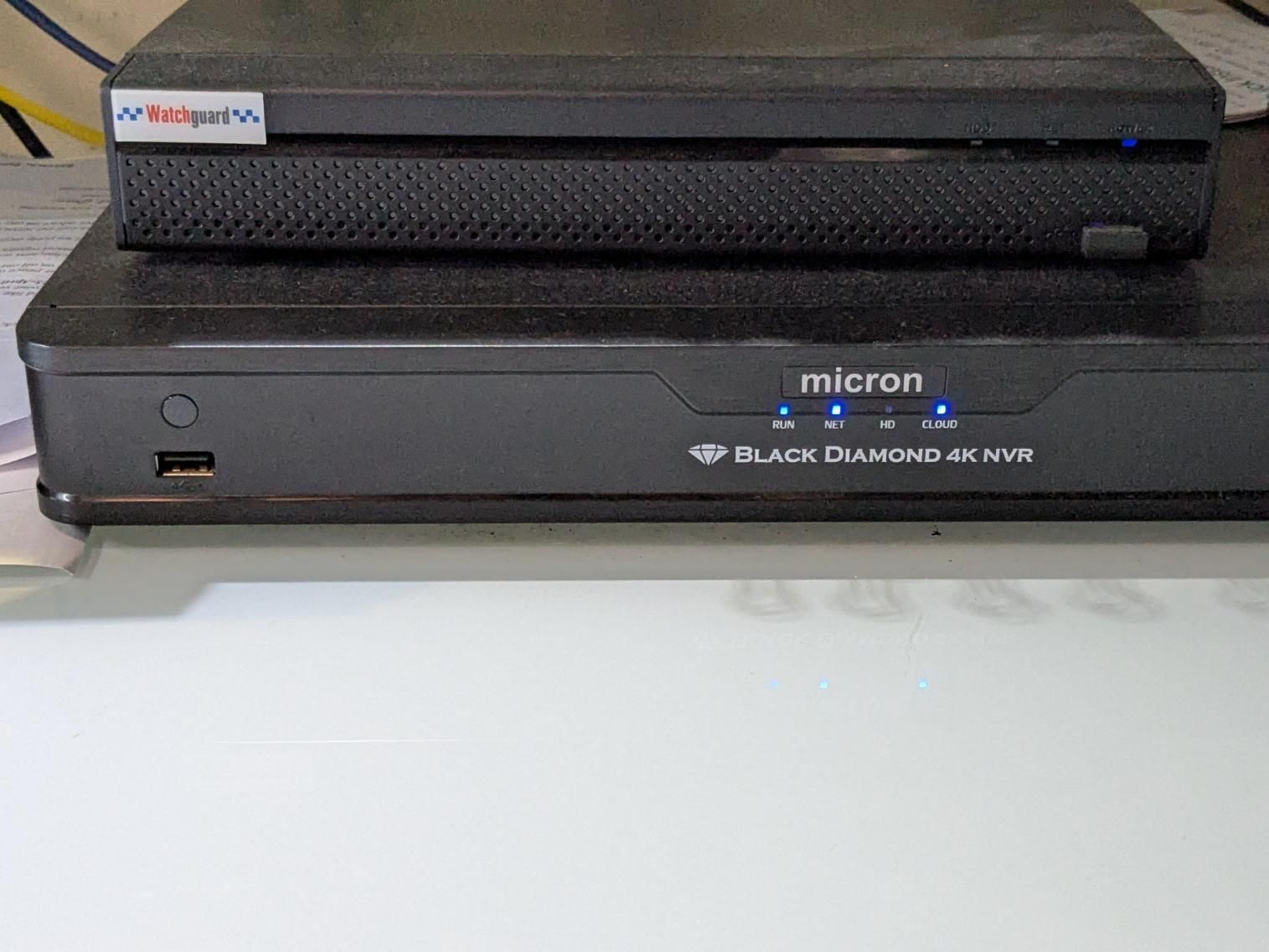 Two Black Boxes Are Sitting on Top of Each Other on a Table — Direct Connect Services In Woombye, QLD