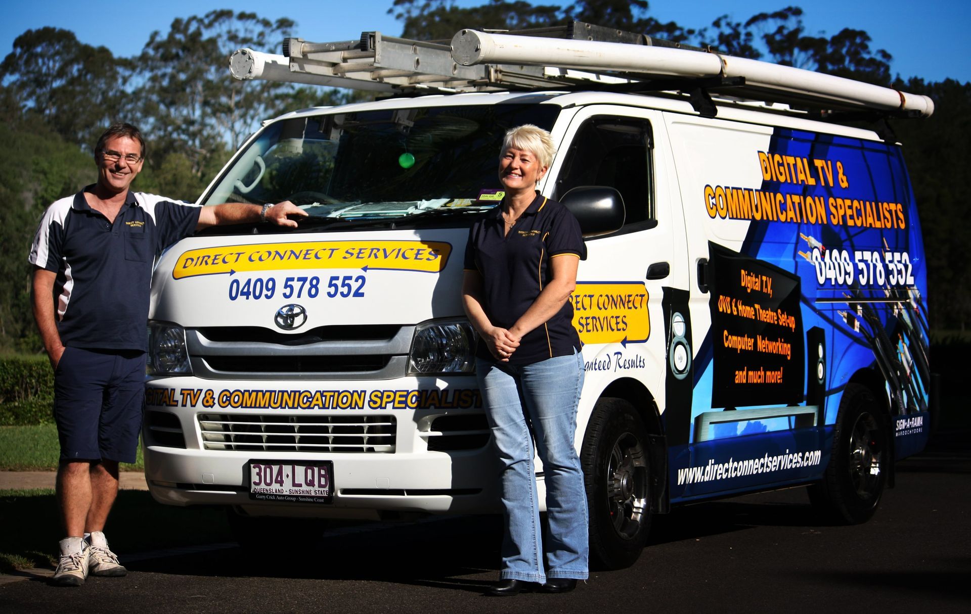 A Man and Woman Standing in Front of a Van — Direct Connect Services In Woombye, QLD