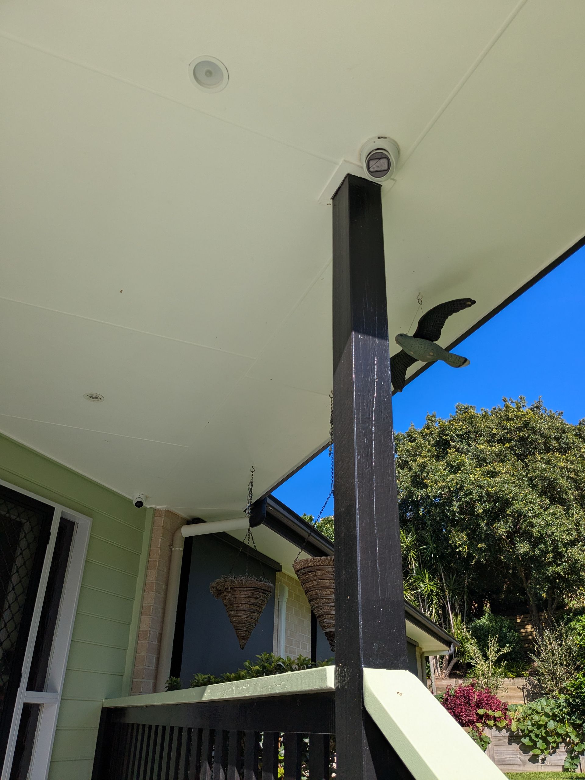 A Cctv Camera is Mounted on the Corner of a Ceiling — Direct Connect Services In Woombye, QLD