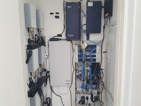 A Room With a Lot of Wires Hanging From the Wall — Direct Connect Services In Woombye, QLD