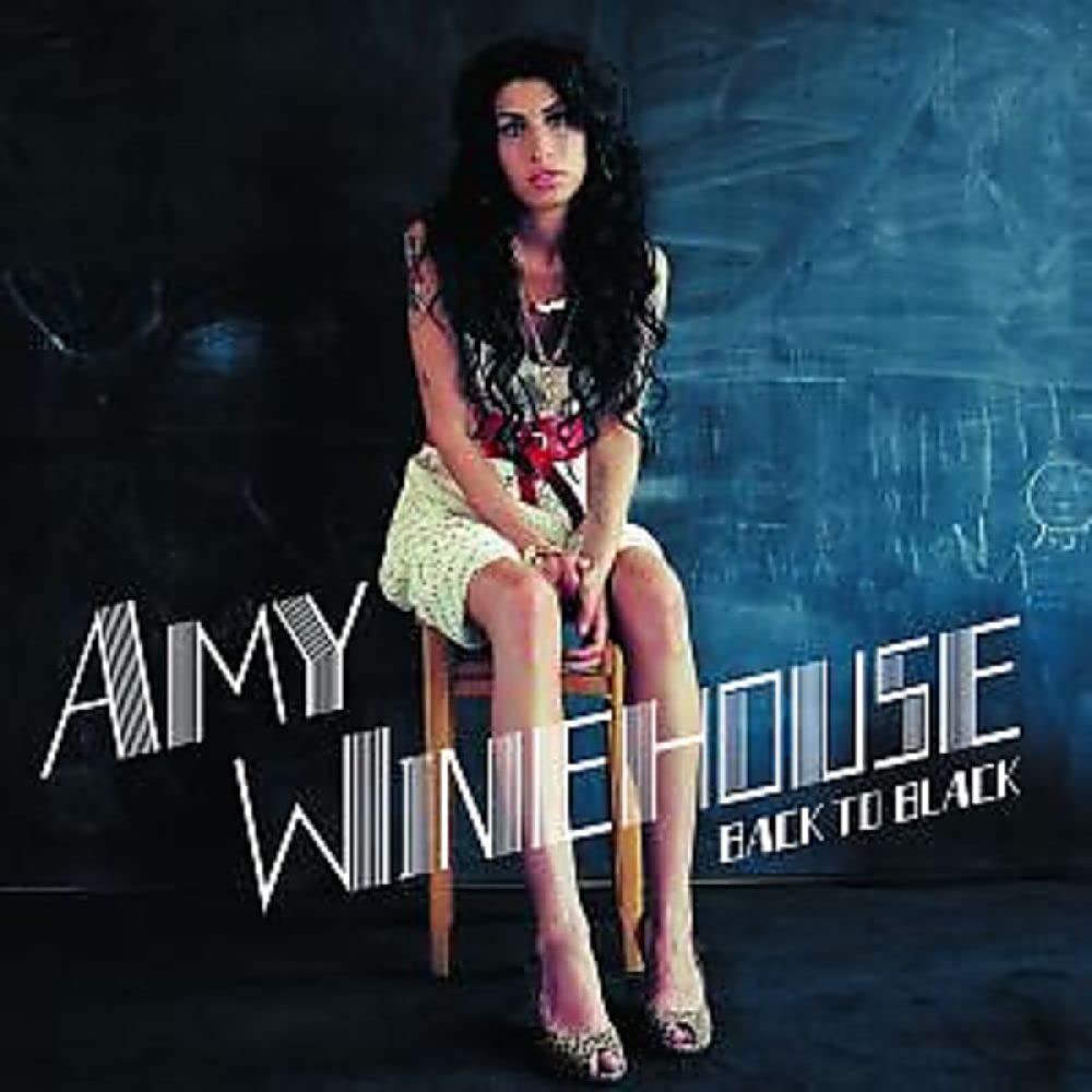 Amy Winehouse sits on a chair in front of a dark background, cover art for the album