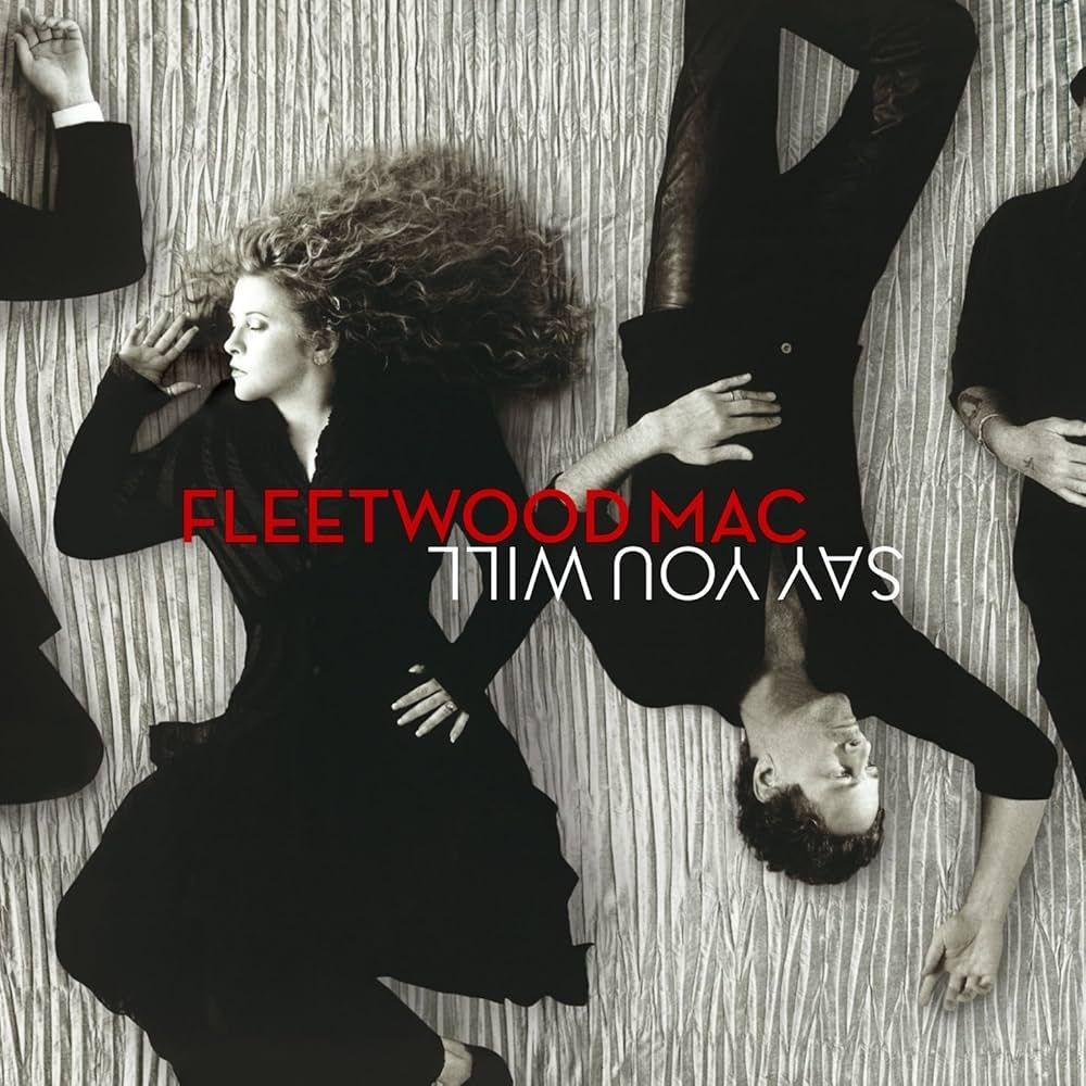 Fleetwood Mac album cover: band members in black outfits against a textured gray backdrop. Singer Stevie Nicks lies down. The title,