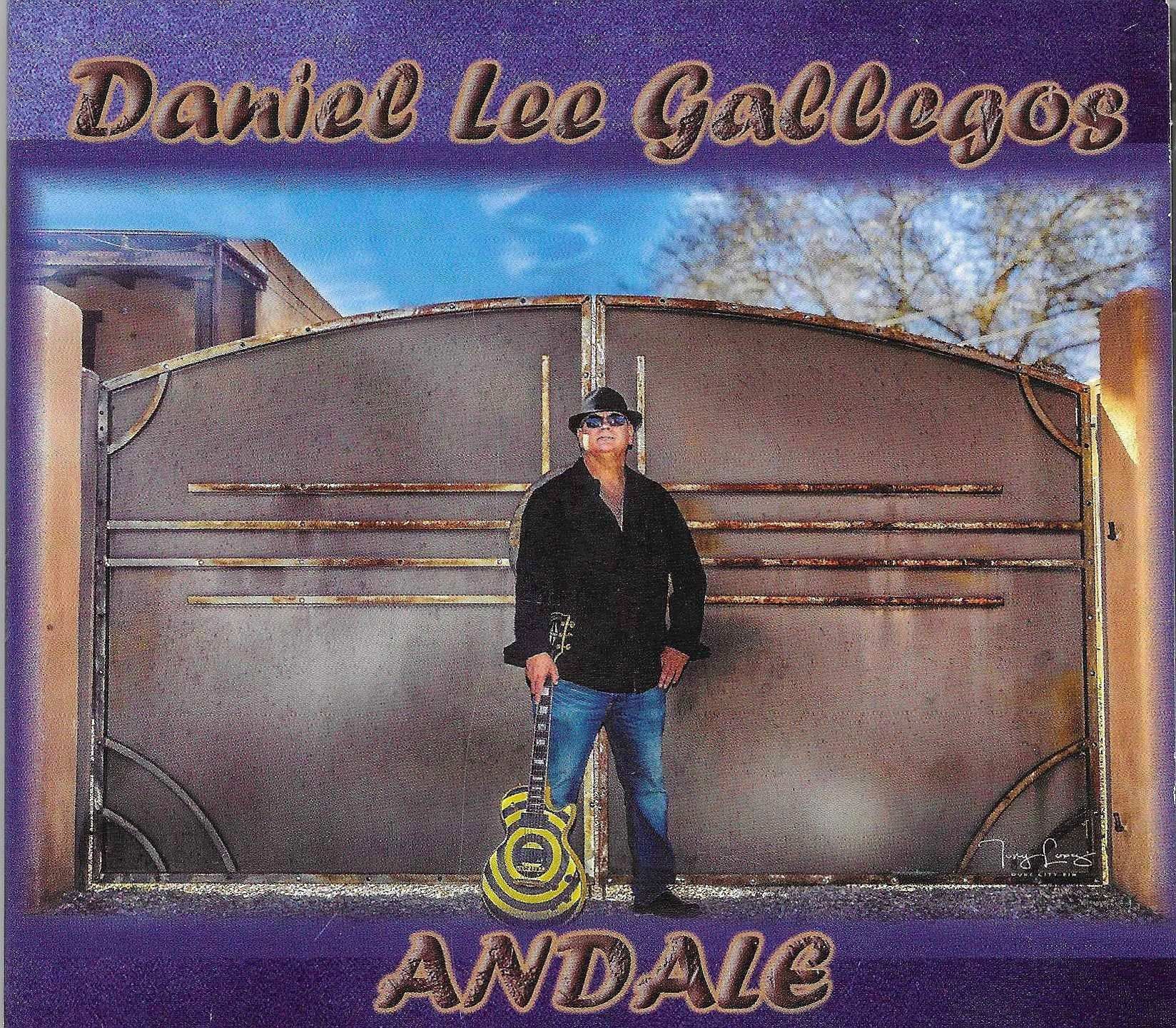 Daniel Lee Gallegos stands with a guitar in front of a large metal gate under a blue sky. The album title