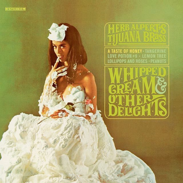 Album cover: A woman covered in whipped cream, surrounded by white, with a band name and album title in vintage font.