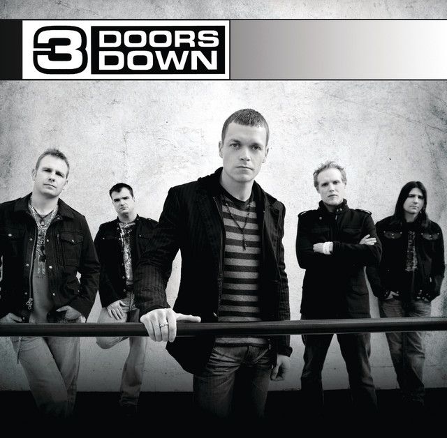 3 Doors Down band members in black and white, standing with a metal bar in front of a concrete wall.