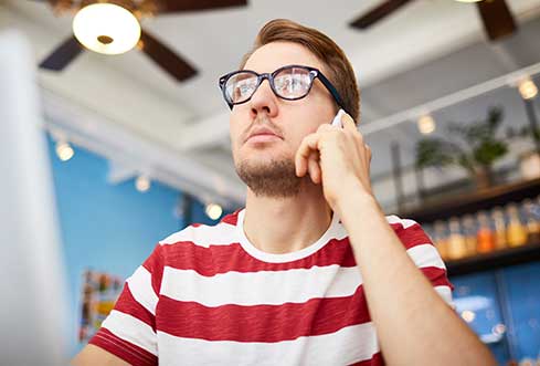 Young man in eyeglasses Inquiring for Movers Services