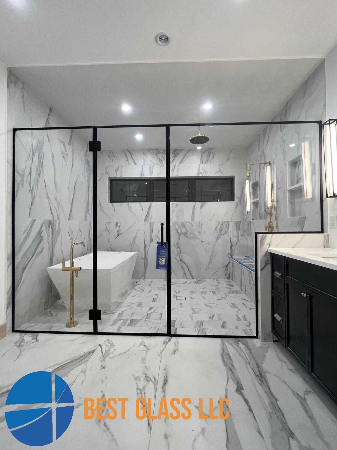 A bathroom with a walk in shower and a bathtub.