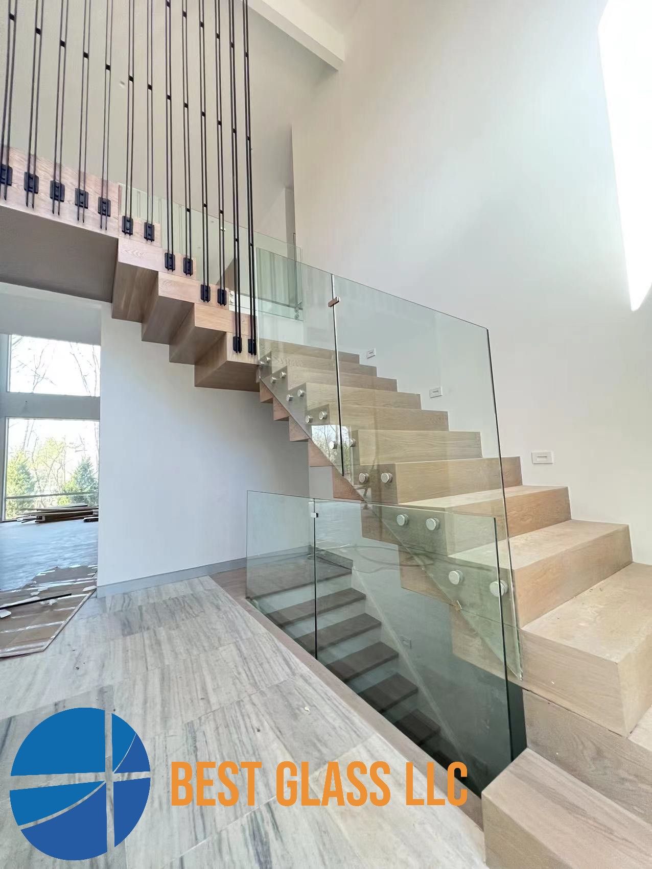 A staircase with a glass railing in a house.