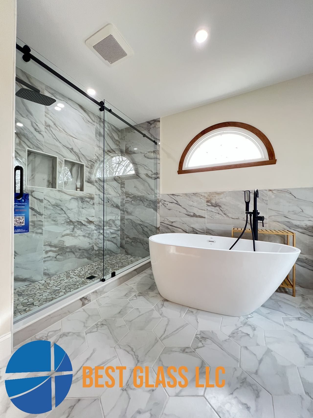 A bathroom with a bathtub and a shower stall.