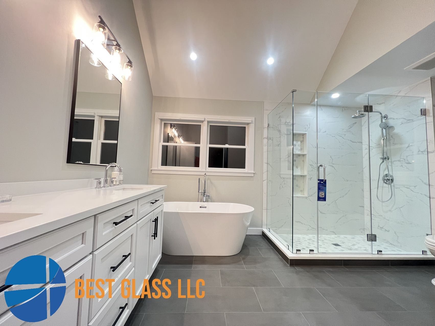 A bathroom with a tub , sink , shower and mirror.