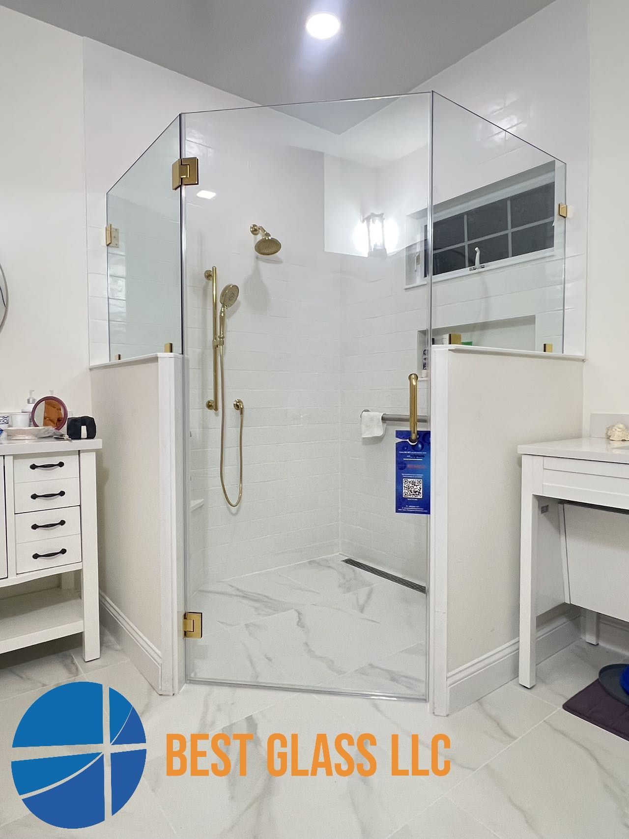 A bathroom with a walk in shower with a glass door.