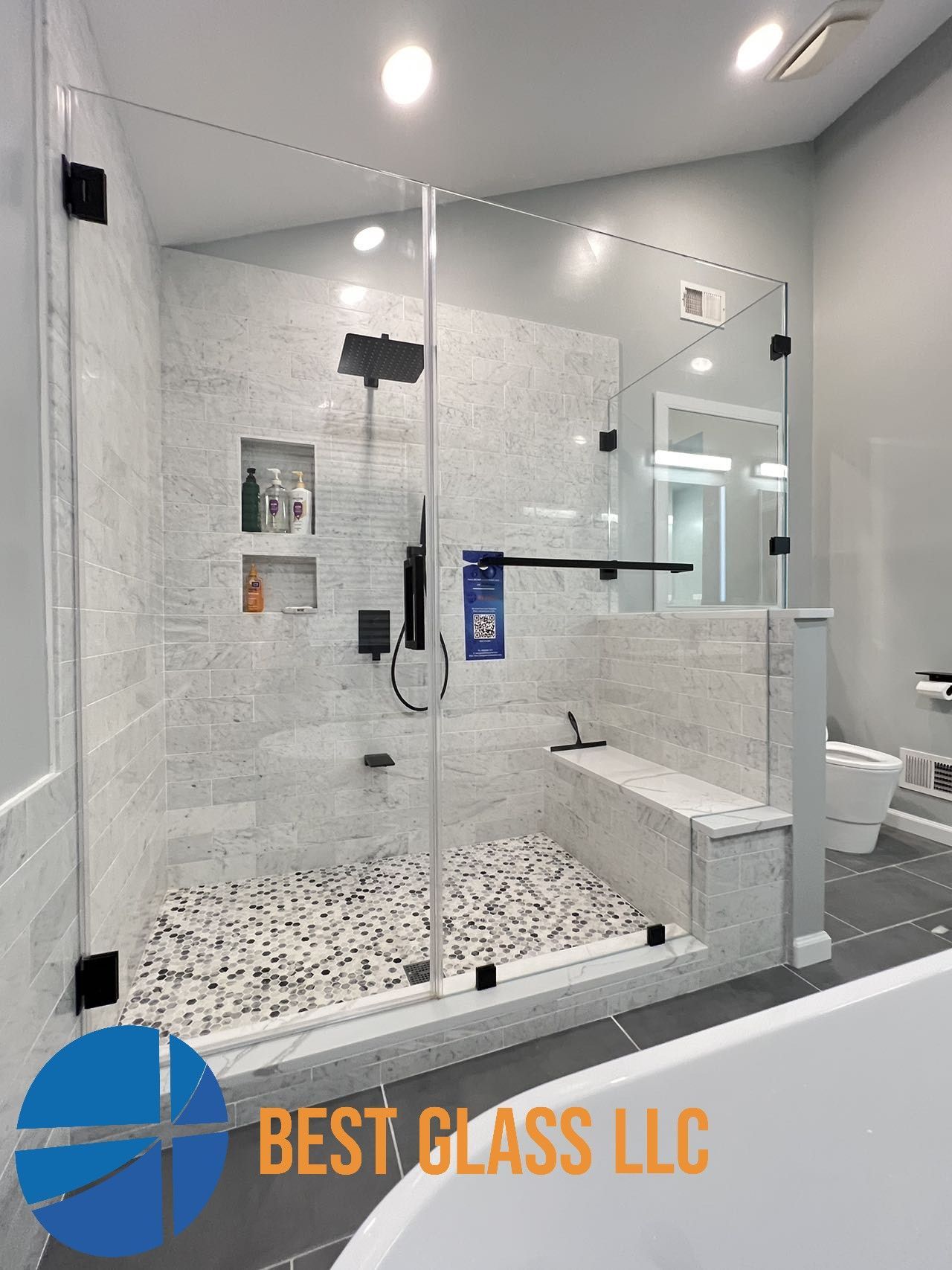 A bathroom with a walk in shower and a bathtub