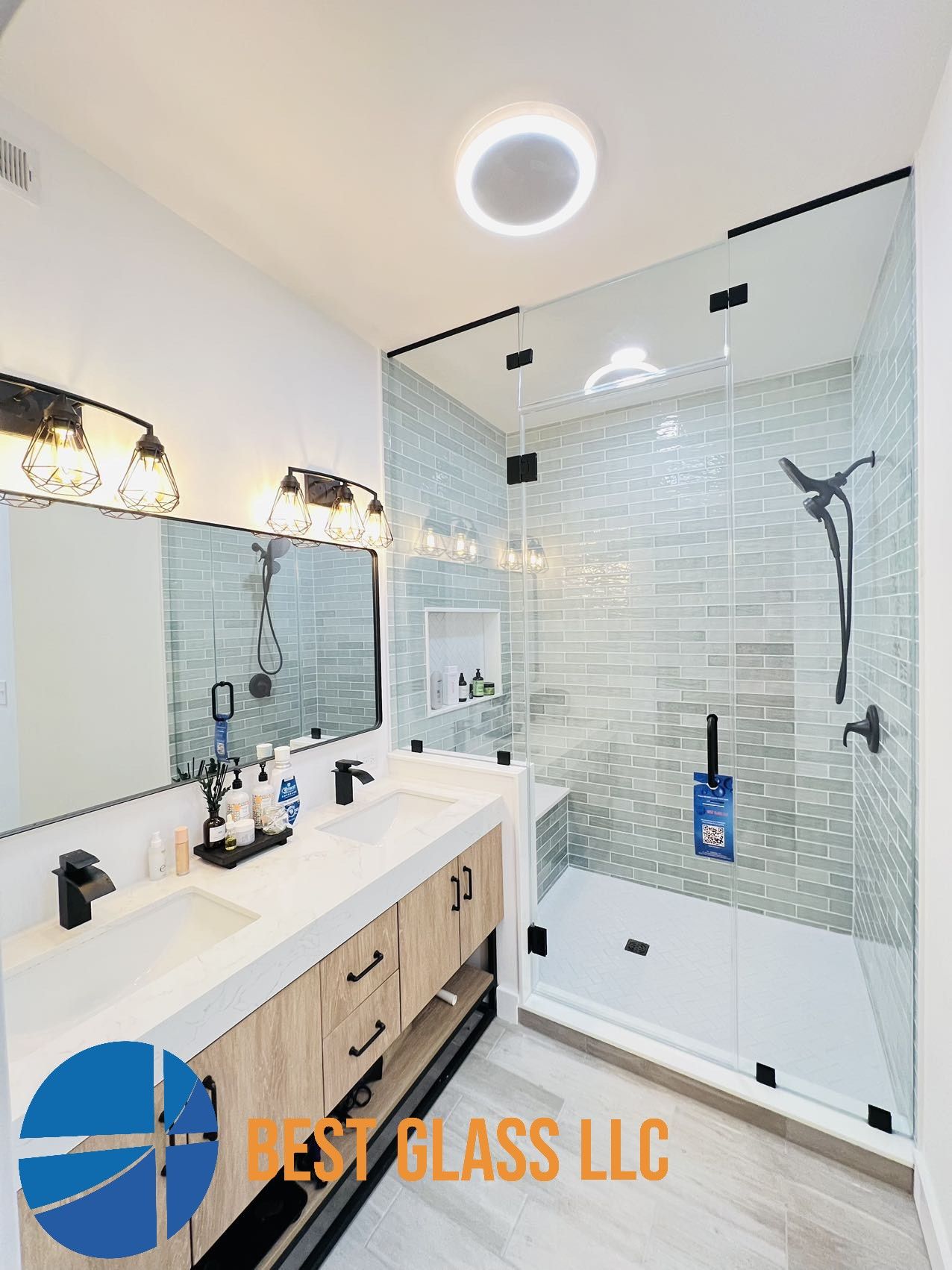 A bathroom with two sinks and a walk in shower.